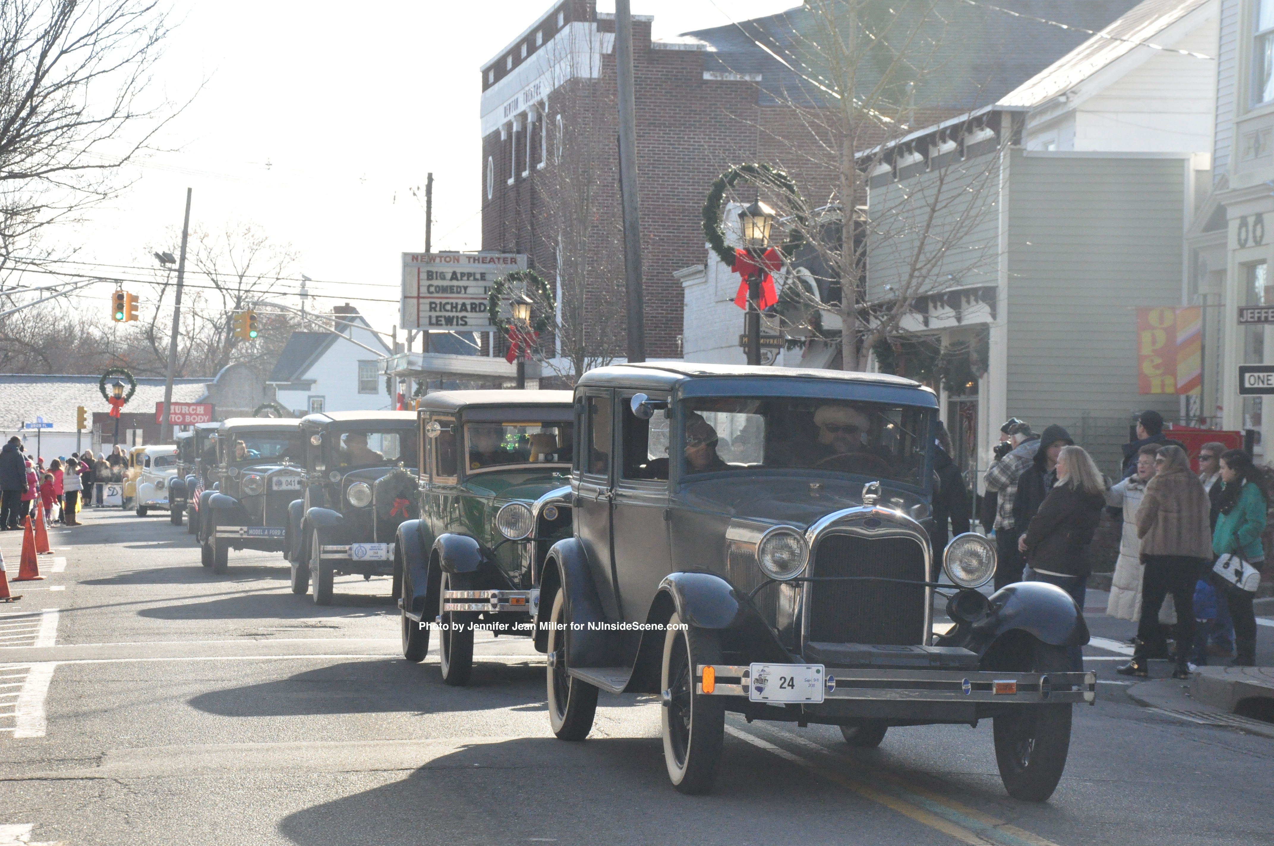 Antique cars file along Spring Street, offering a nod to yesteryear.