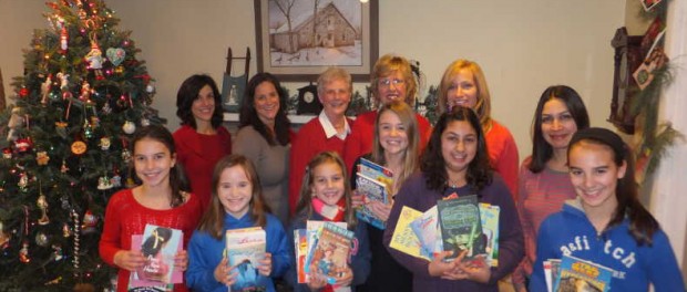 L-R, Back row: book volunteers Betsy Groome, Kelly Merwin, Karen Curd, Elaine Furfero, Erin Ryan, Vaishali Dhand; Front Row: Katie Groome, Kate Ryan, Kelly Groome, Kenzie Merwin, Raina Dhand and Corinne Groome hold some of the books collected to be donated to Newton Medical Center and other organizations