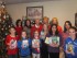 L-R, Back row: book volunteers Betsy Groome, Kelly Merwin, Karen Curd, Elaine Furfero, Erin Ryan, Vaishali Dhand; Front Row: Katie Groome, Kate Ryan, Kelly Groome, Kenzie Merwin, Raina Dhand and Corinne Groome hold some of the books collected to be donated to Newton Medical Center and other organizations
