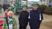 Three spirited Newton youngsters from left to right: Lucas Fox, age five, Jason Teets age eight and his brother Patrick Teets, also eight, are ready for the parade. Lucas and his mother passed out green fortune cookies to those they knew. Photo by Jennifer Jean Miller.