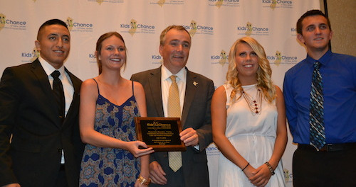 New Jersey Labor Commissioner Harold J. Wirths (center) holds a plaque commemorating his support for Kid's Chance New Jersey, which issued six scholarships, each for $10,000, to students who had a parent killed or catastrophically injured at work. Scholarship recipients included (from left to right) Pedro Morejon of Lyndhurst, Alexandra Kurnath and Mackenzie Kurnath of Seaside Park (formerly of Chester) and Scott Kwiatek of South Amboy. The two other scholarship recipients were Marie Molinaro of Rockaway and Trent Schamble of Vernon.