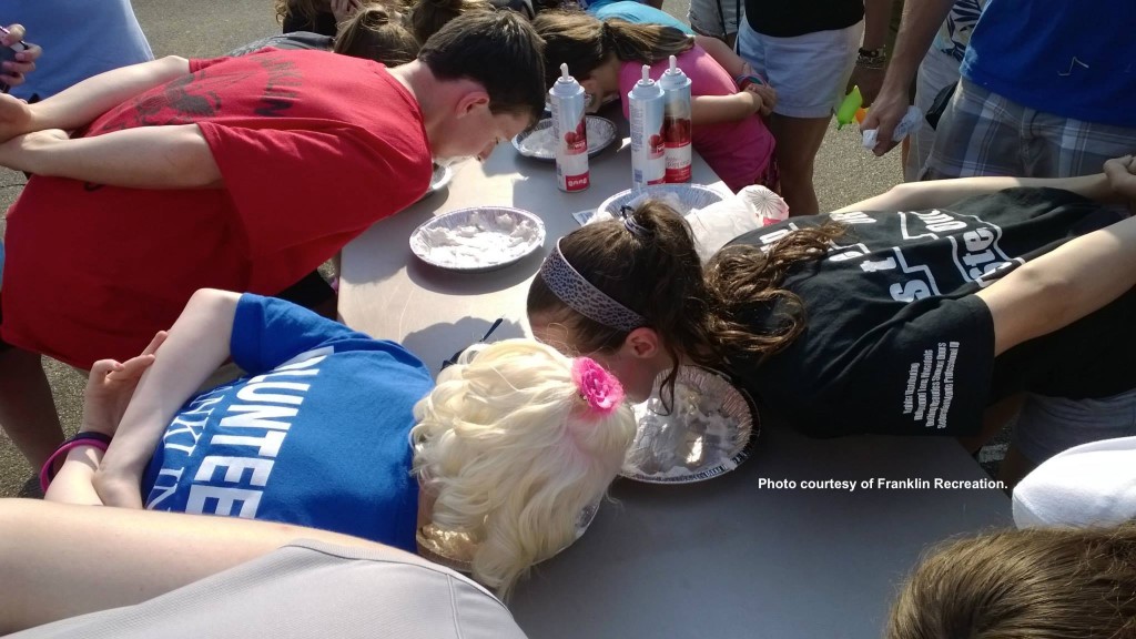 Pie-eating participants lunge into whipped-cream filled concoctions. Photo courtesy of Franklin Recreation.