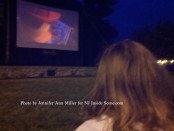 A youngster watches The Lego Movie on the jumbo screen in the park. Photo by Jennifer Jean Miller.