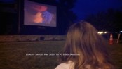 A youngster watches The Lego Movie on the jumbo screen in the park. Photo by Jennifer Jean Miller.