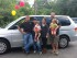 NAPA Sales Representative Jim Messina (left) and Elite Automotive owner Dave Hergert (right) congratulate Yolanda Dones and her family on the acquisition of a refurbished van as part of the auto donation program at Project Self-Sufficiency.