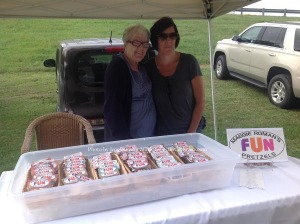 Delia Lowery (left) and her daughter Maggie Lowery (right) with their handcrafted pretzel treats, Maggie Roman's Fun Pretzels. Photo by Jennifer Jean Miller.
