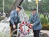 Newton Police Officer Scott King (left) and Hopatcong Police Officer Edward Janosko (right) carry the wreath to the monument. Photo by Jennifer Jean Miller.