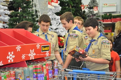 Scouts from Boy Scout Troop 150 inspect gift items they purchased. Photo by Jennifer Jean Miller.