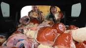 Labor Commissioner Harold J. Wirths and his wife, Debbie, load 125 Christmas hams outside the Weis Supermarket in Franklin, Sussex County, for packaging with other goods and gifts for needy families. Photo courtesy of New Jersey Department of Labor and Workforce Development.