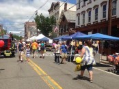 Attendees enjoy Newton Day early in the day on Spring Street under the blue skies and sunshine. Photo by Jennifer Jean Miller.