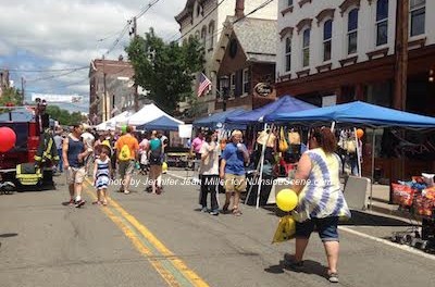 Attendees enjoy Newton Day early in the day on Spring Street under the blue skies and sunshine. Photo by Jennifer Jean Miller.