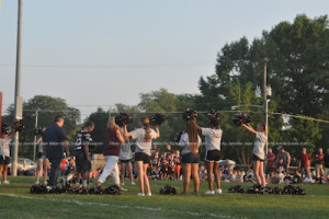 Cheerleaders welcome varsity players onto the field. Photo by Jennifer Jean Miller. 
