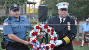 Newton Patrolman Mahir Kaylani (left) and Newton Fire Department's Jason Miller (right) carry the wreath in remembrance of 9/11 victims. Photo by Jennifer Jean Miller.