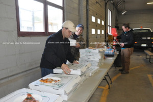 One of the volunteers choosing a piece of pizza. Photo by Jennifer Jean Miller.