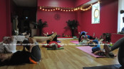 Guests at PEARLL Yoga's anniversary event take in a yoga class. Photo by Jennifer Jean Miller.