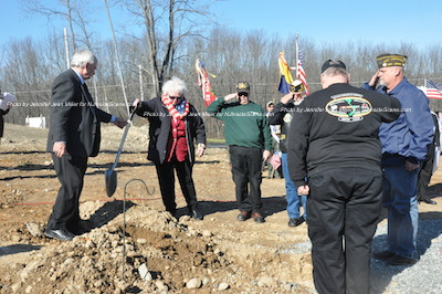 John Harrigan (far left) passes the shovel to the next member of the cemetery board. Photo by Jennifer Jean Miller. 