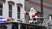 Santa atop the Newton Fire Department ladder truck waves to the crowd. Photo by Jennifer Jean Miller.