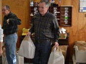 Commissioner Harold J. Wirths of the New Jersey Department of Labor and Workforce Development helps volunteers at the Sussex United Methodist Church organize and bag complete Thanksgiving dinners to be distributed to needy families throughout Sussex County. Image provided.