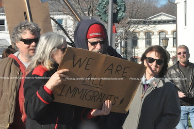 The Demonstrators offer a message that all in the United States are immigrants. Photo by Jennifer Jean Miller.