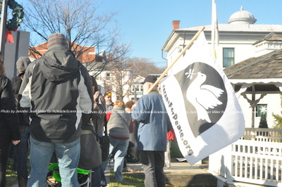 Waving the Veterans for Peace banner. Photo by Jennifer Jean Miller. 