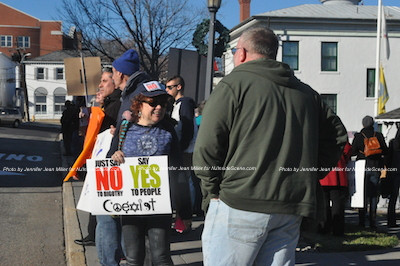 Demonstrators toting signs with the "Coexist" message. Photo by Jennifer Jean Miller. 