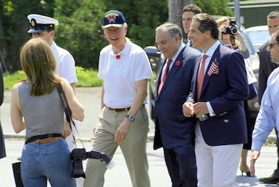 Bill Clinton, with Bob Castelli and Andrew Cuomo in the Chappaqua Memorial Day Parade, 2012, creative commons image. 