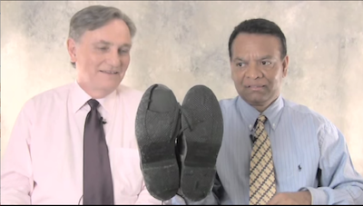 Stanley Praimnath and Brian Clark, who became friends after Clark rescued Praimnath on 9/11/01, marvel at the condition of Praimnath's shoes from the events that day. Image courtesy of Guideposts/YouTube.